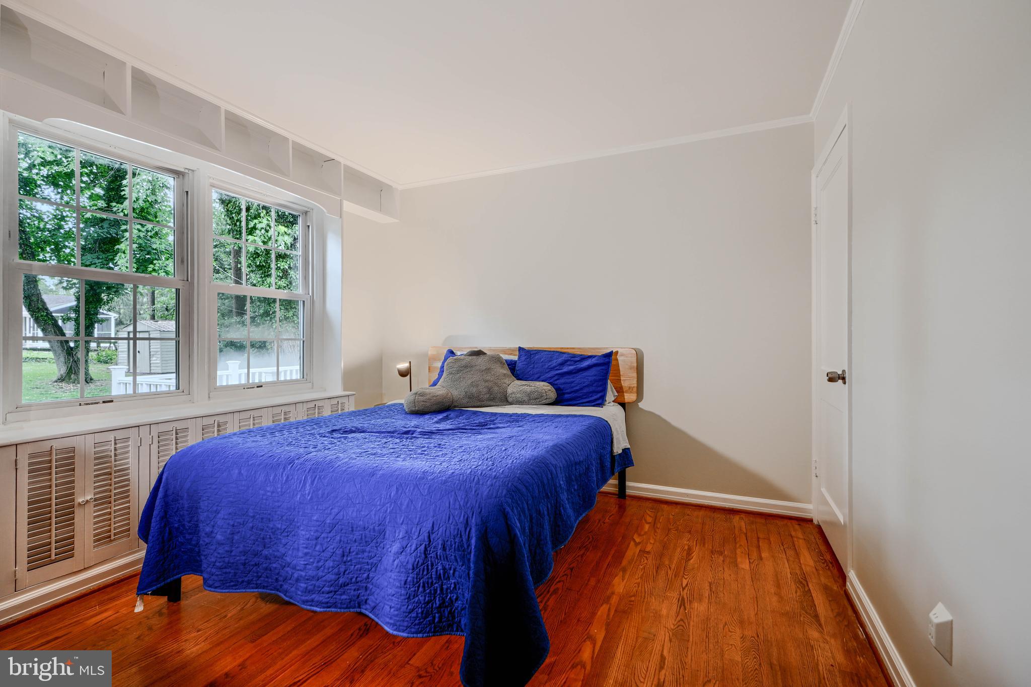 8808 Wolverton Road Baltimore, MD 21234 - Photo 27 of 57 a bedroom with a bed and wooden floor