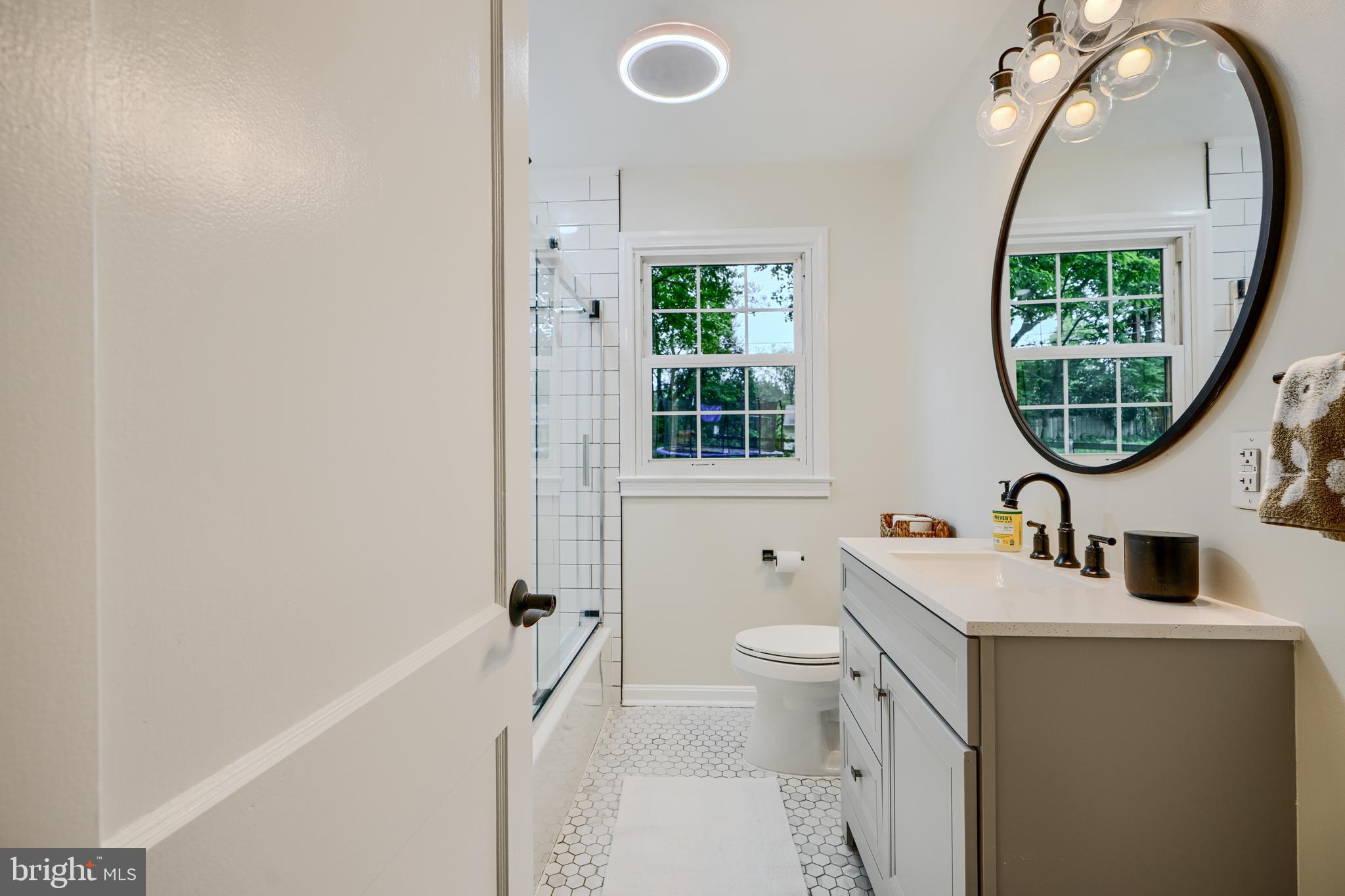 8808 Wolverton Road Baltimore, MD 21234 - Photo 34 of 57 a bathroom with a sink toilet and a mirror