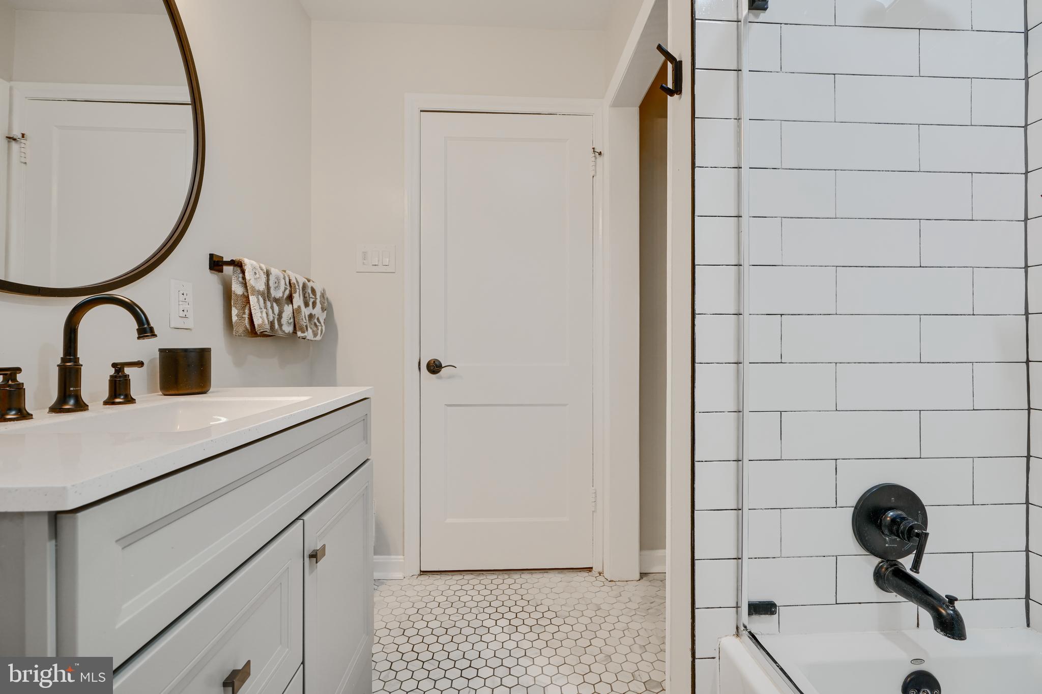 8808 Wolverton Road Baltimore, MD 21234 - Photo 36 of 57 a bathroom with a sink a toilet and a mirror