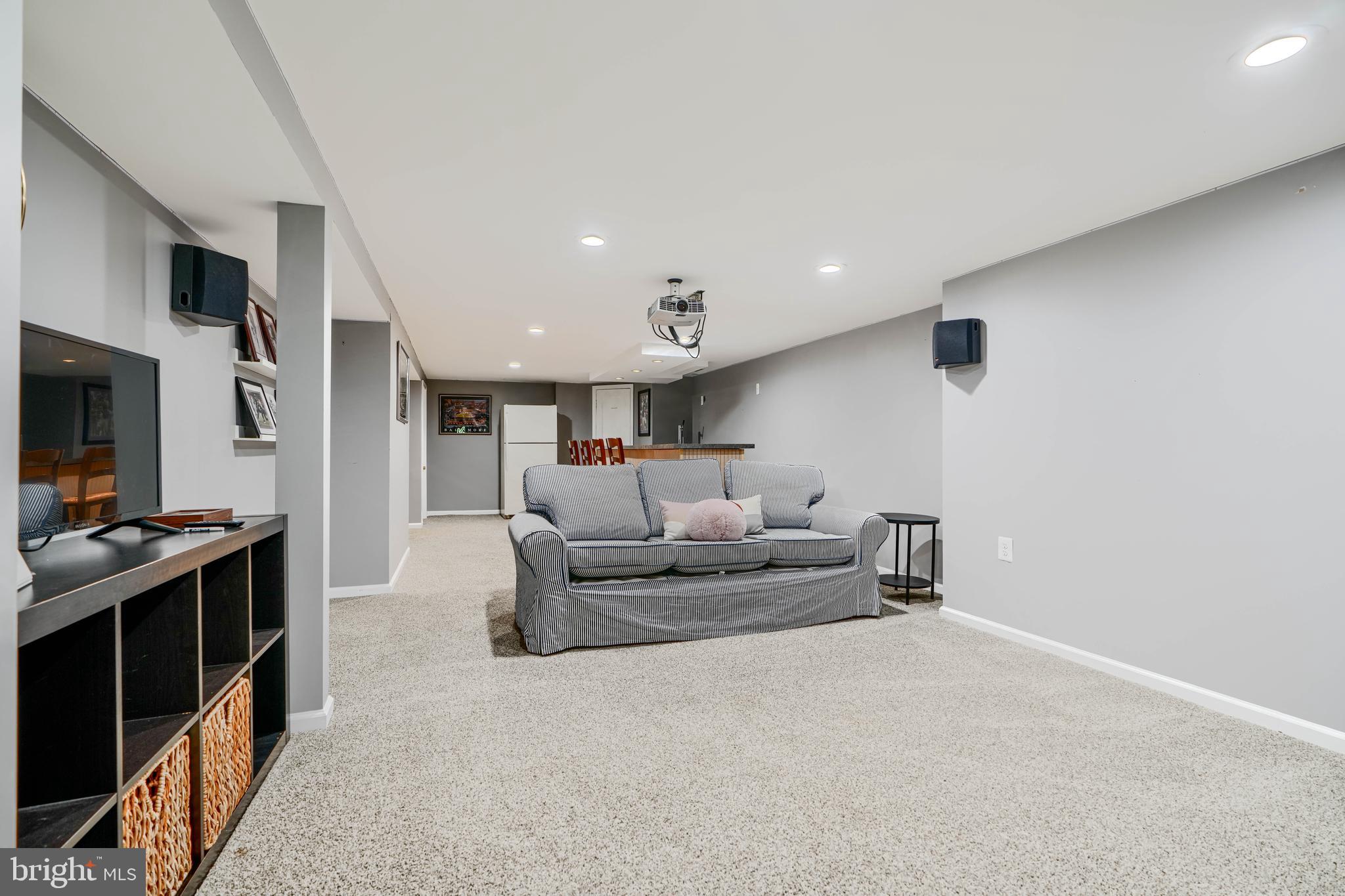 8808 Wolverton Road Baltimore, MD 21234 - Photo 40 of 57 a living room with furniture and a flat screen tv