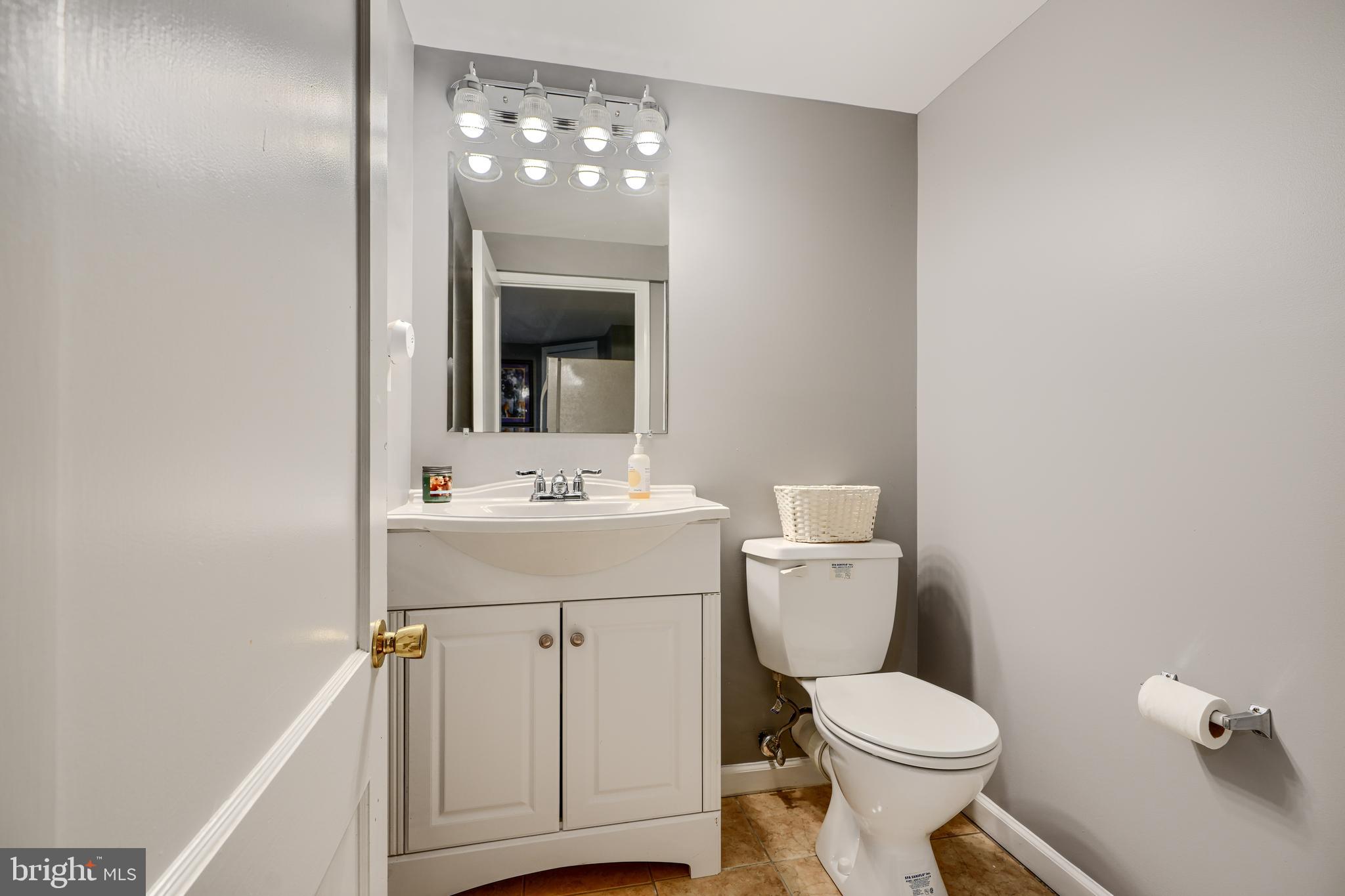 8808 Wolverton Road Baltimore, MD 21234 - Photo 41 of 57 a bathroom with a toilet a sink and mirror