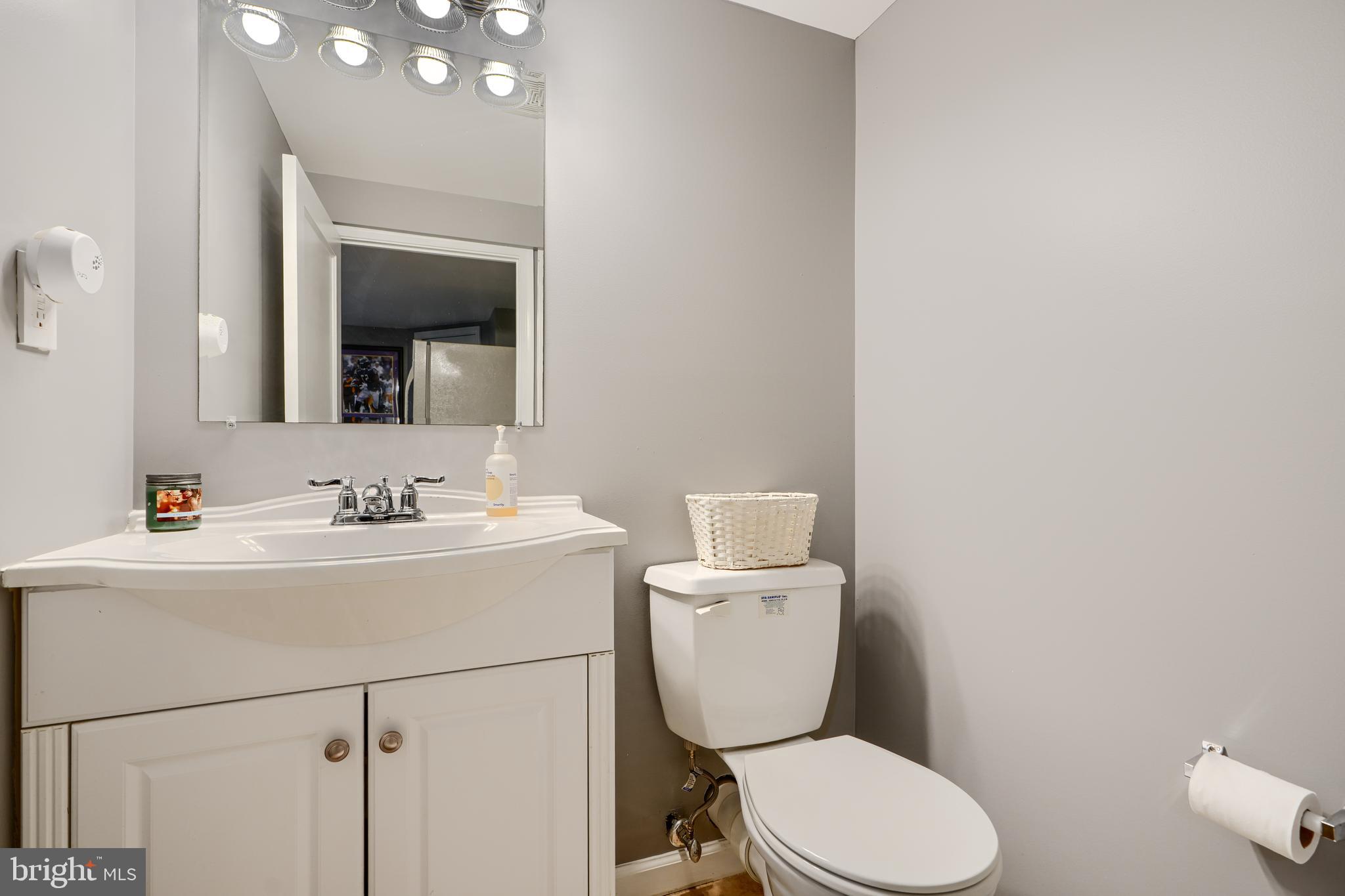 8808 Wolverton Road Baltimore, MD 21234 - Photo 42 of 57 a bathroom with a toilet sink and mirror