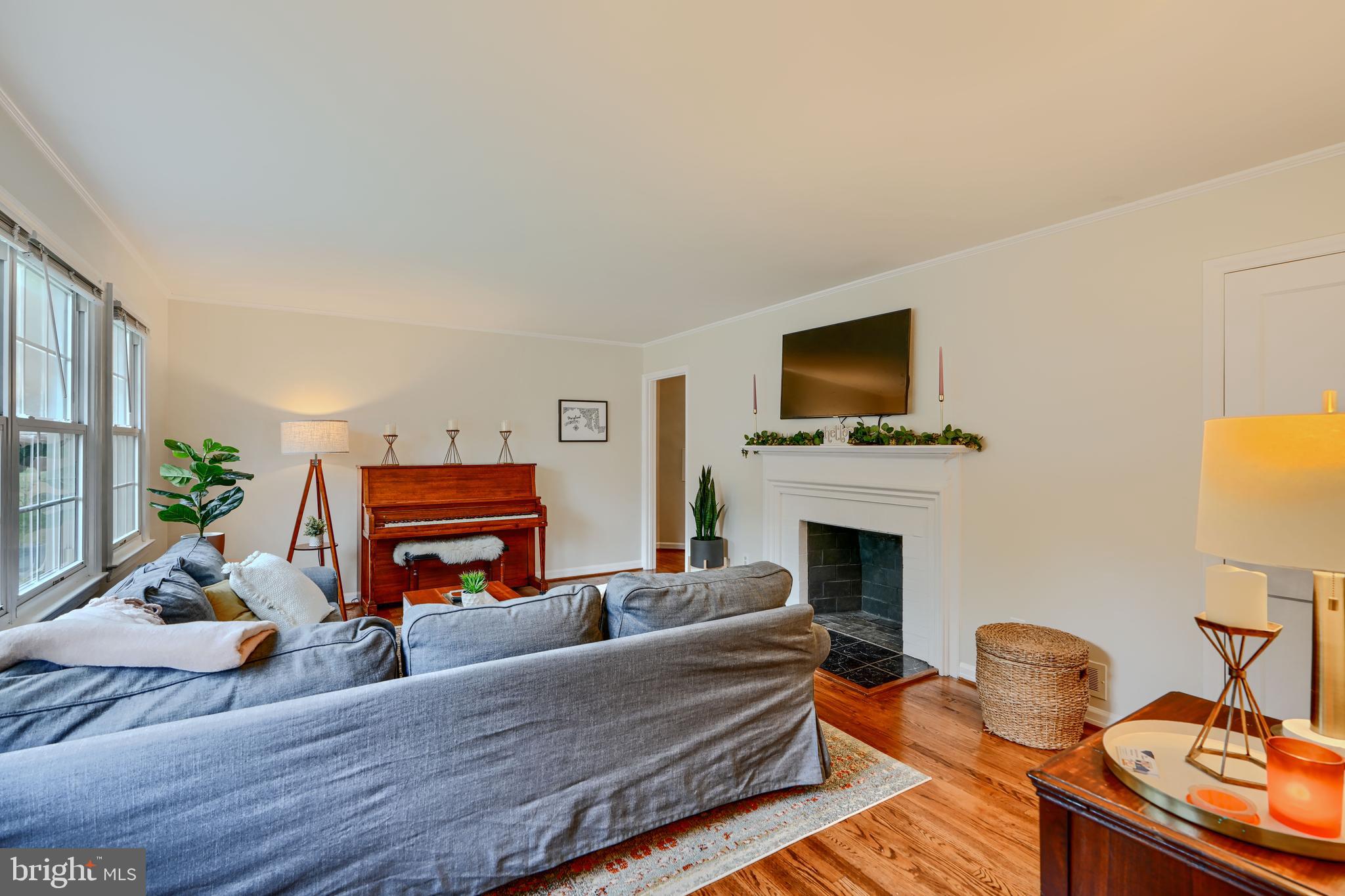 8808 Wolverton Road Baltimore, MD 21234 - Photo 8 of 57 a living room with furniture a fireplace and a flat screen tv