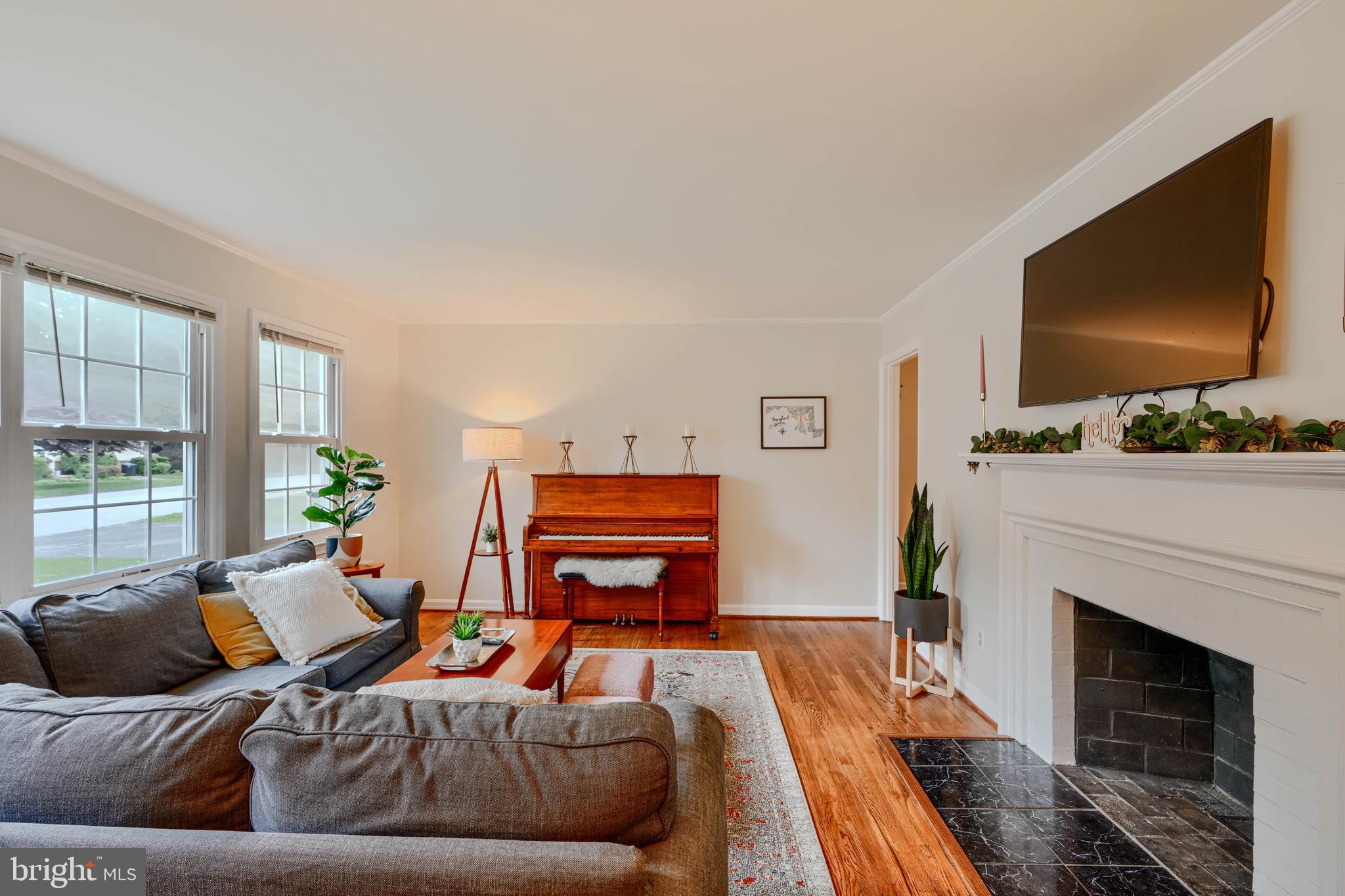 8808 Wolverton Road Baltimore, MD 21234 - Photo 9 of 57 a living room with furniture a flat screen tv and a fireplace