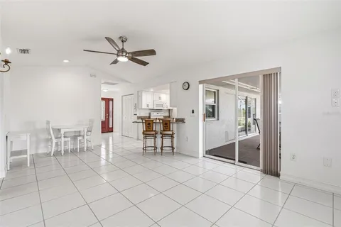 a living room with furniture a dining table and chairs
