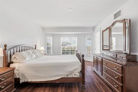 a bedroom with a bed a table and chair