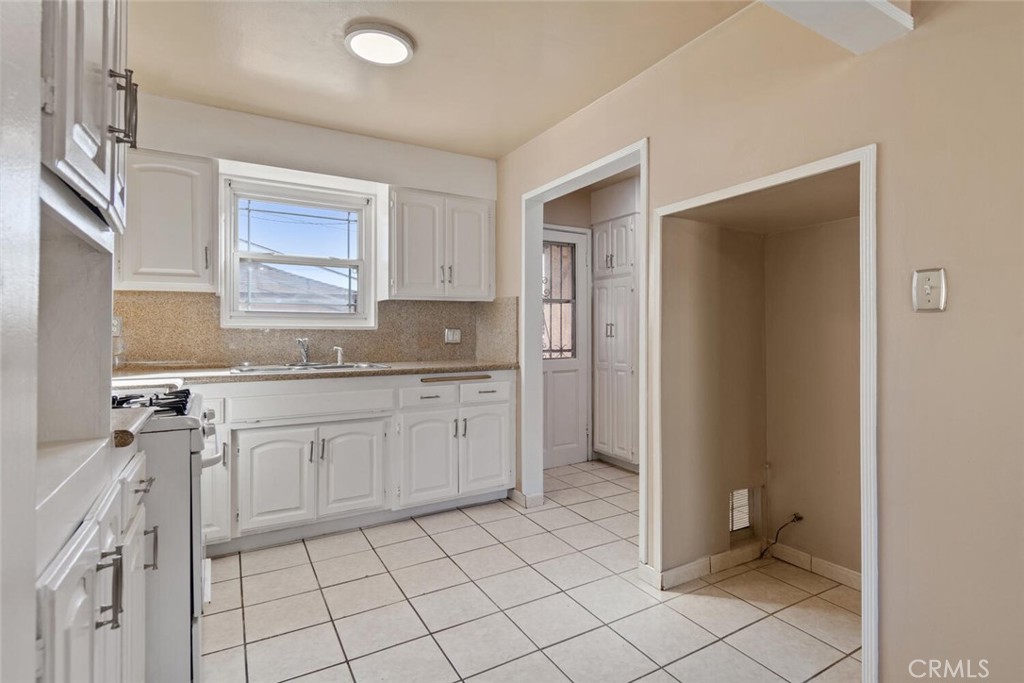 13438 Mercer Street Pacoima, CA 91331 - Photo 12 of 39 a spacious bathroom with a granite countertop sink mirror and toilet
