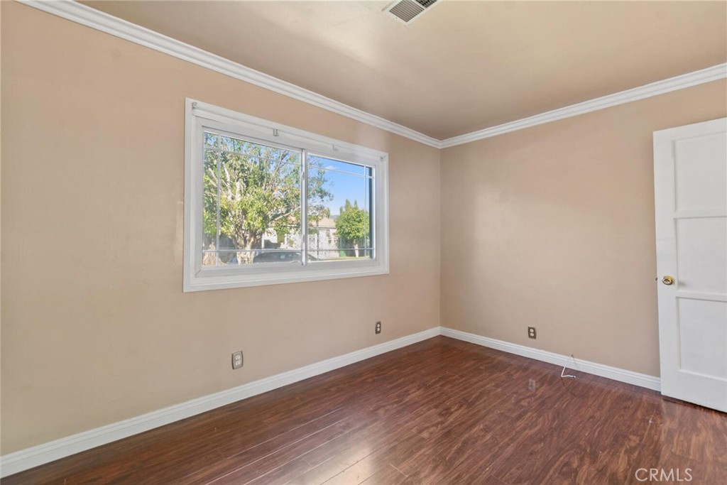 13438 Mercer Street Pacoima, CA 91331 - Photo 15 of 39 wooden floor in an empty room with a window