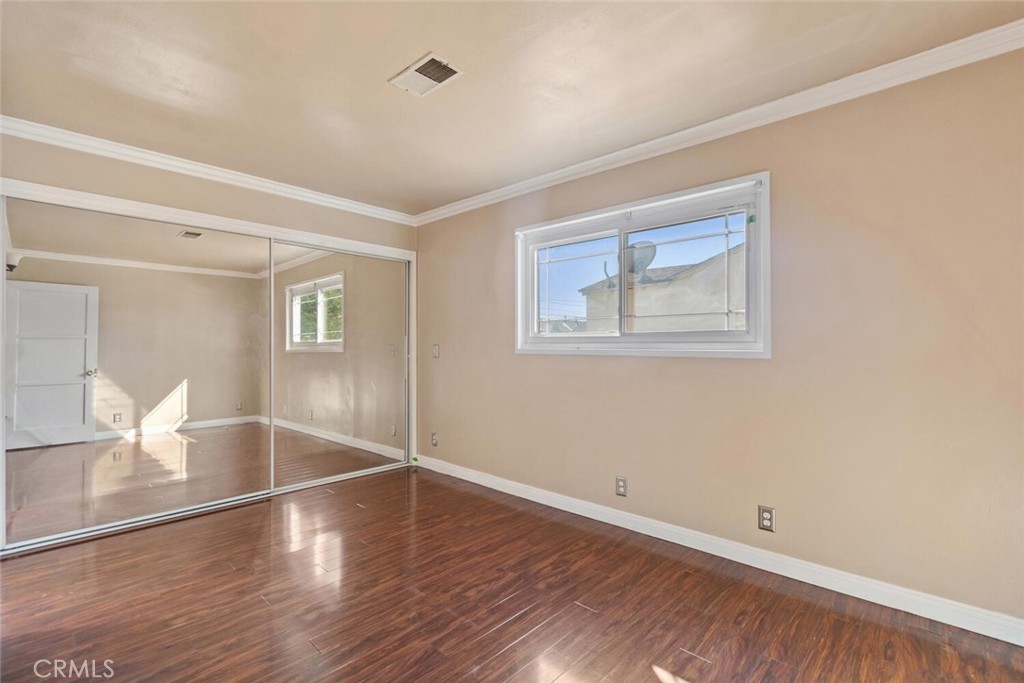 13438 Mercer Street Pacoima, CA 91331 - Photo 18 of 39 a view of empty room with wooden floor and fan