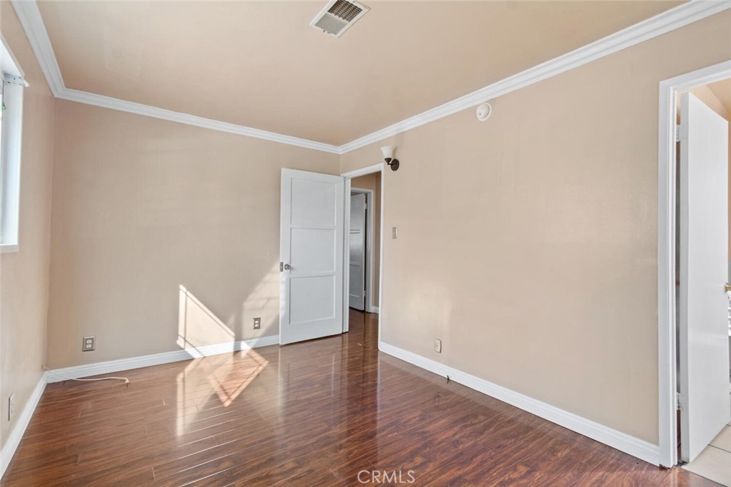 13438 Mercer Street Pacoima, CA 91331 - Photo 20 of 39 a view of an empty room with wooden floor