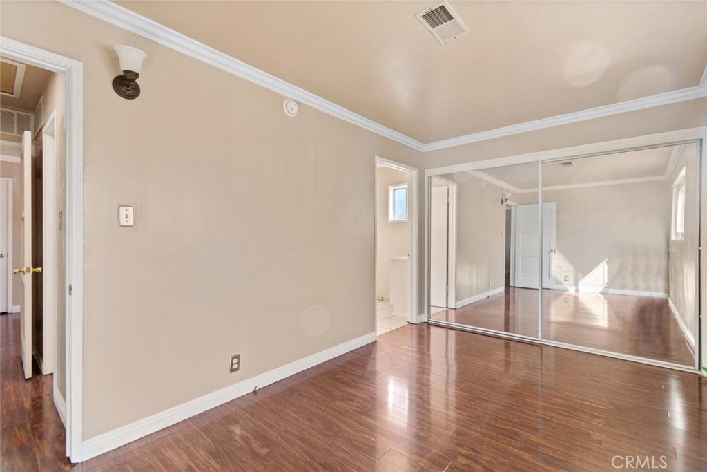 13438 Mercer Street Pacoima, CA 91331 - Photo 21 of 39 a view of an empty room with wooden floor