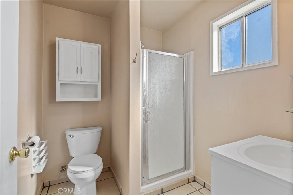 13438 Mercer Street Pacoima, CA 91331 - Photo 22 of 39 a bathroom with a toilet sink and shower