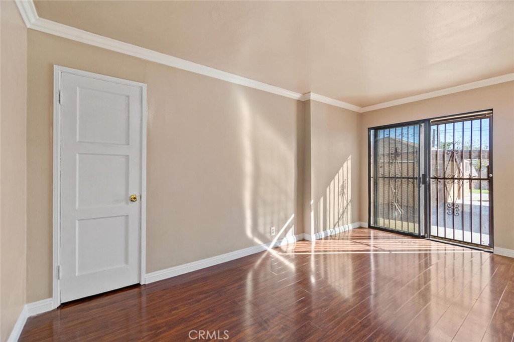 13438 Mercer Street Pacoima, CA 91331 - Photo 23 of 39 an empty room with wooden floor and windows