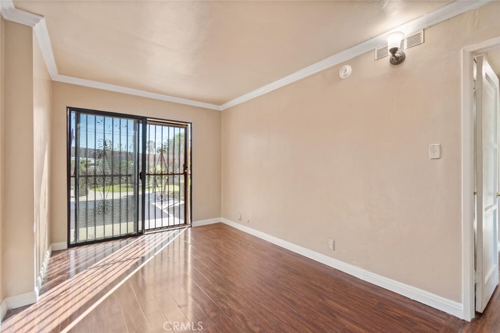 13438 Mercer Street Pacoima, CA 91331 - Photo 24 of 39 a view of an empty room with wooden floor and a window