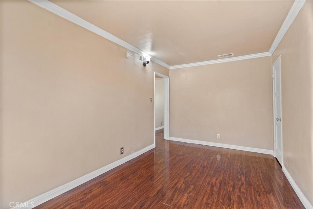 13438 Mercer Street Pacoima, CA 91331 - Photo 26 of 39 a view of an empty room with wooden floor