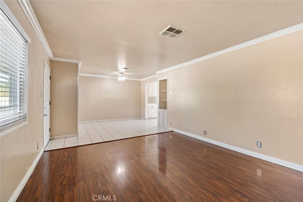13438 Mercer Street Pacoima, CA 91331 - Photo 7 of 39 an empty room with wooden floor and windows