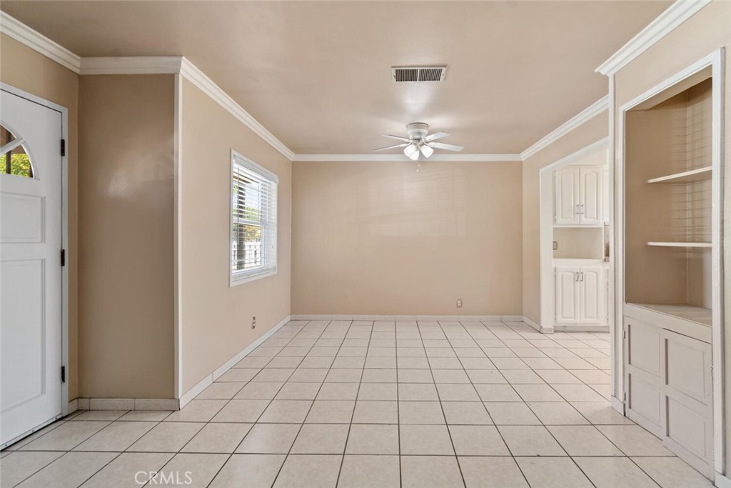 13438 Mercer Street Pacoima, CA 91331 - Photo 8 of 39 a view of an empty room with window and chandelier fan