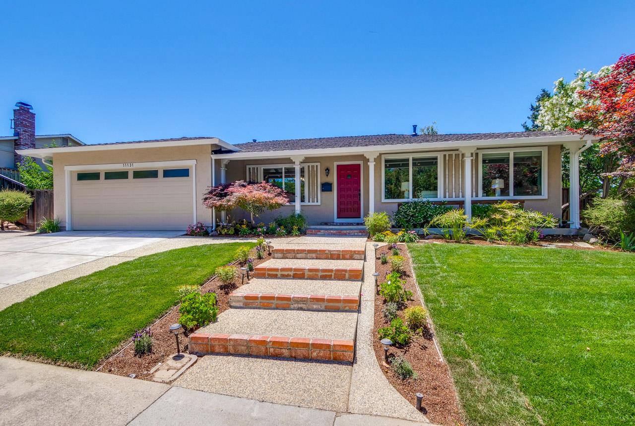 a front view of house with yard and green space