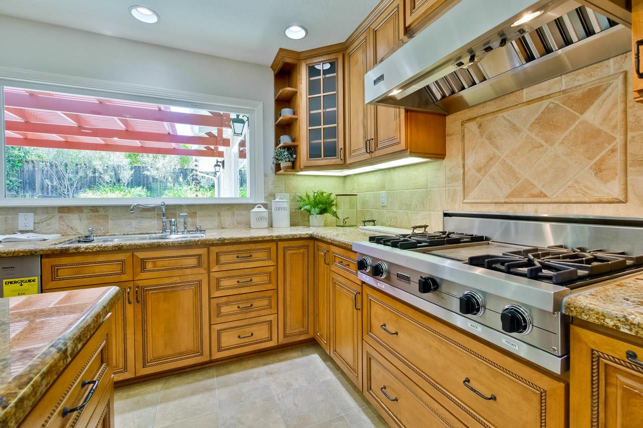 11131 Bubb Road Cupertino, CA 95014 - Photo 16 of 56 a kitchen with stainless steel appliances a stove a sink and a large window