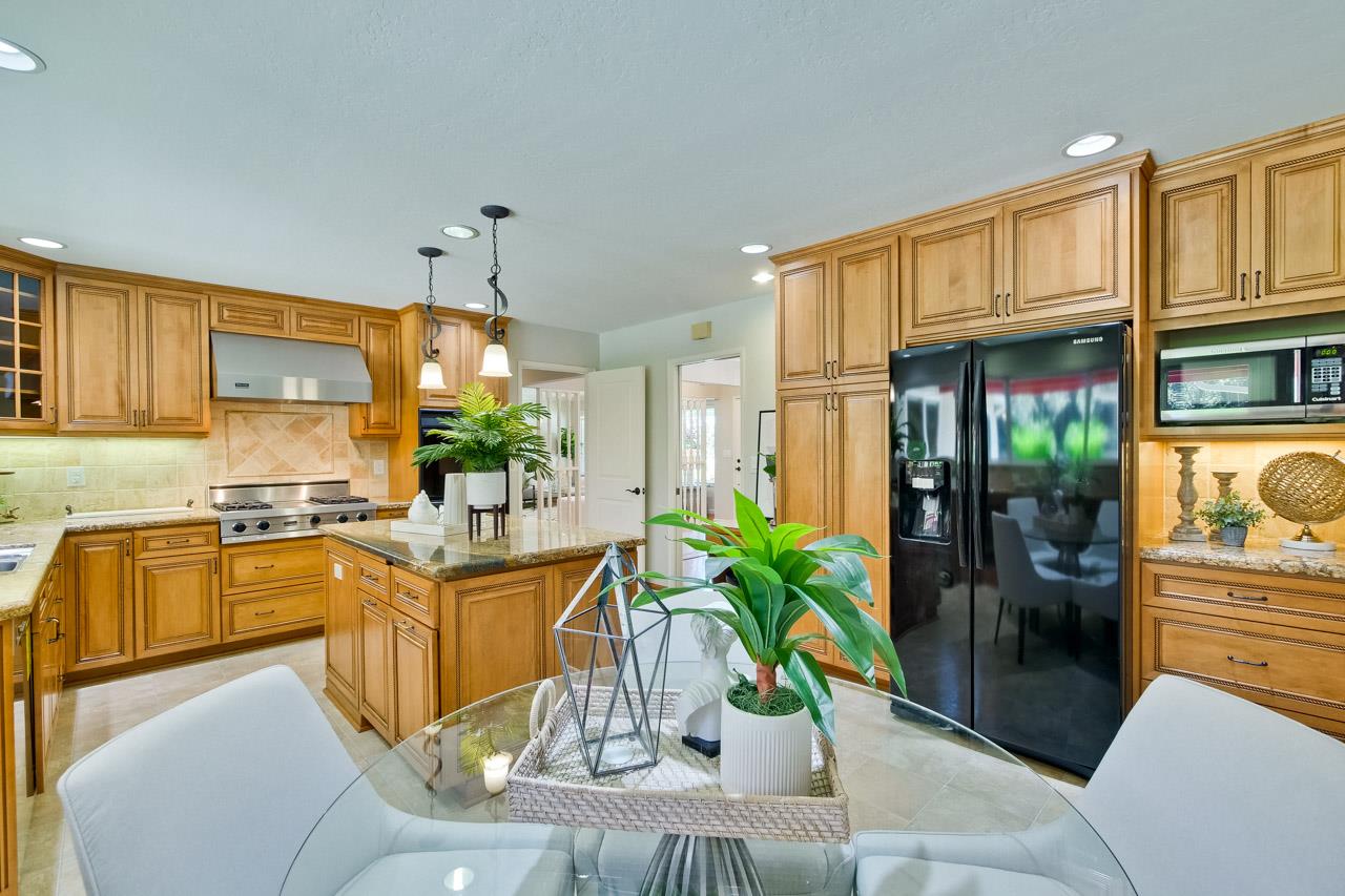 11131 Bubb Road Cupertino, CA 95014 - Photo 19 of 56 a kitchen with stainless steel appliances granite countertop sink stove top oven and cabinets