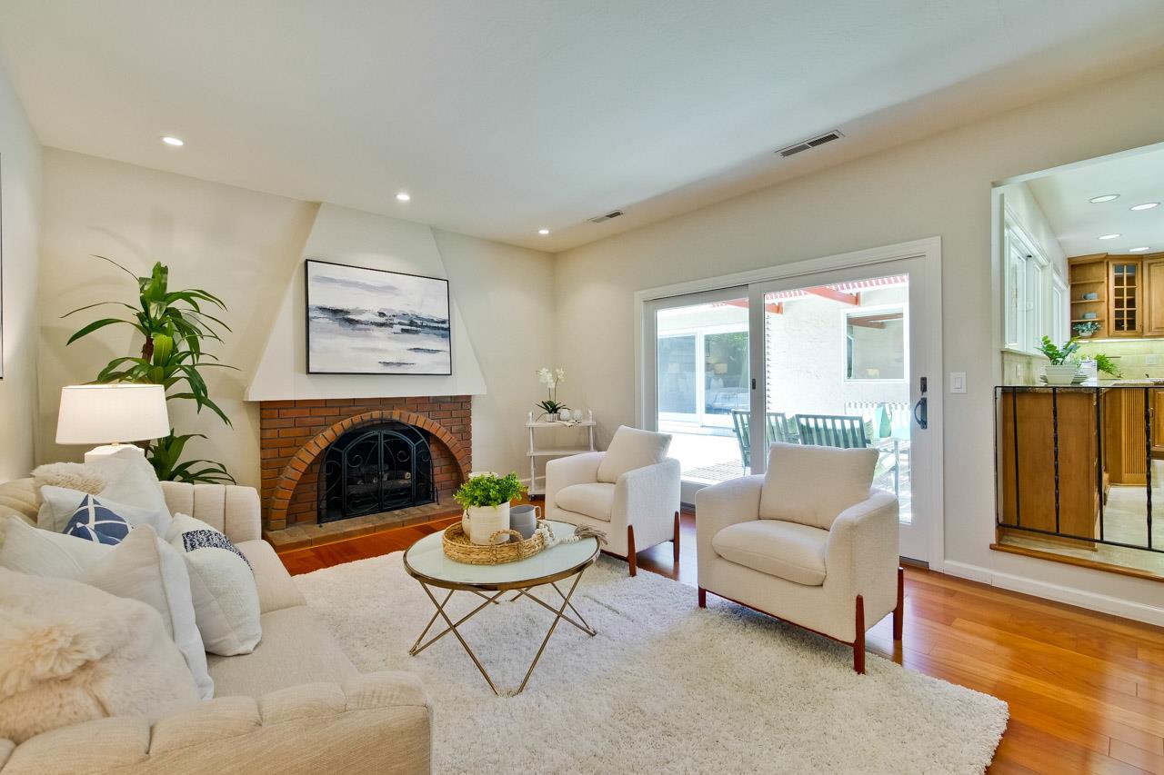 11131 Bubb Road Cupertino, CA 95014 - Photo 27 of 56 a living room with furniture fireplace and a table