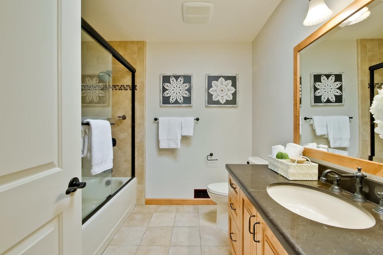 11131 Bubb Road Cupertino, CA 95014 - Photo 37 of 56 a bathroom with a granite countertop sink a mirror and a bathtub