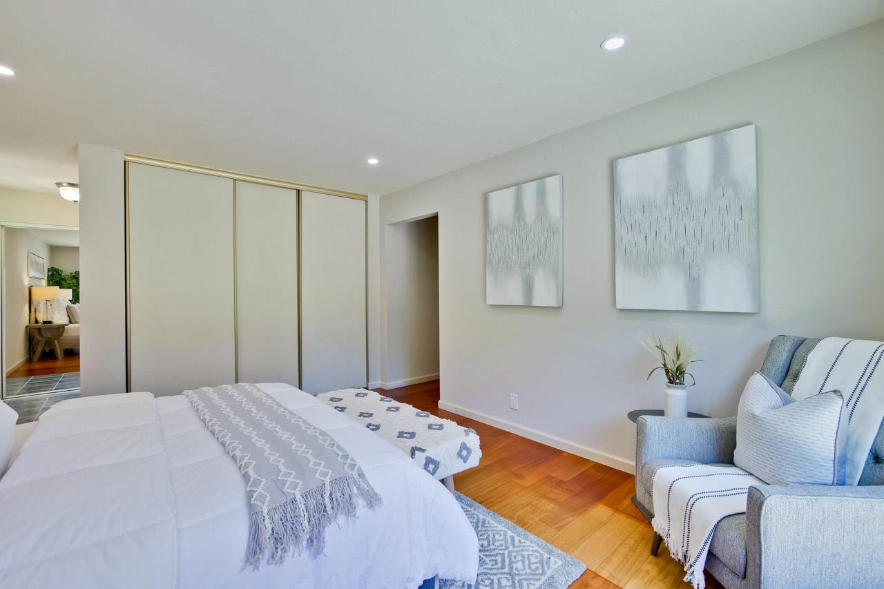 11131 Bubb Road Cupertino, CA 95014 - Photo 45 of 56 a bedroom with a bed couches chair and wall painting