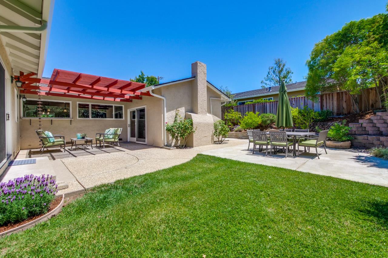 11131 Bubb Road Cupertino, CA 95014 - Photo 49 of 56 a view of a patio with table and chairs potted plants and a palm tree