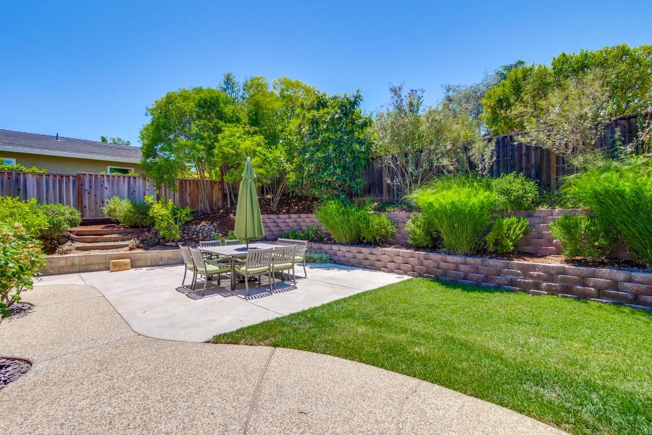 11131 Bubb Road Cupertino, CA 95014 - Photo 52 of 56 a view of a patio with table and chairs potted plants and palm tree