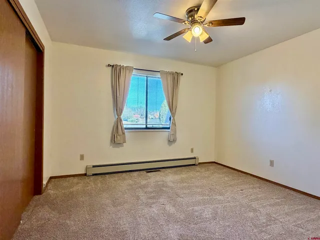a view of an empty room with a cabinet