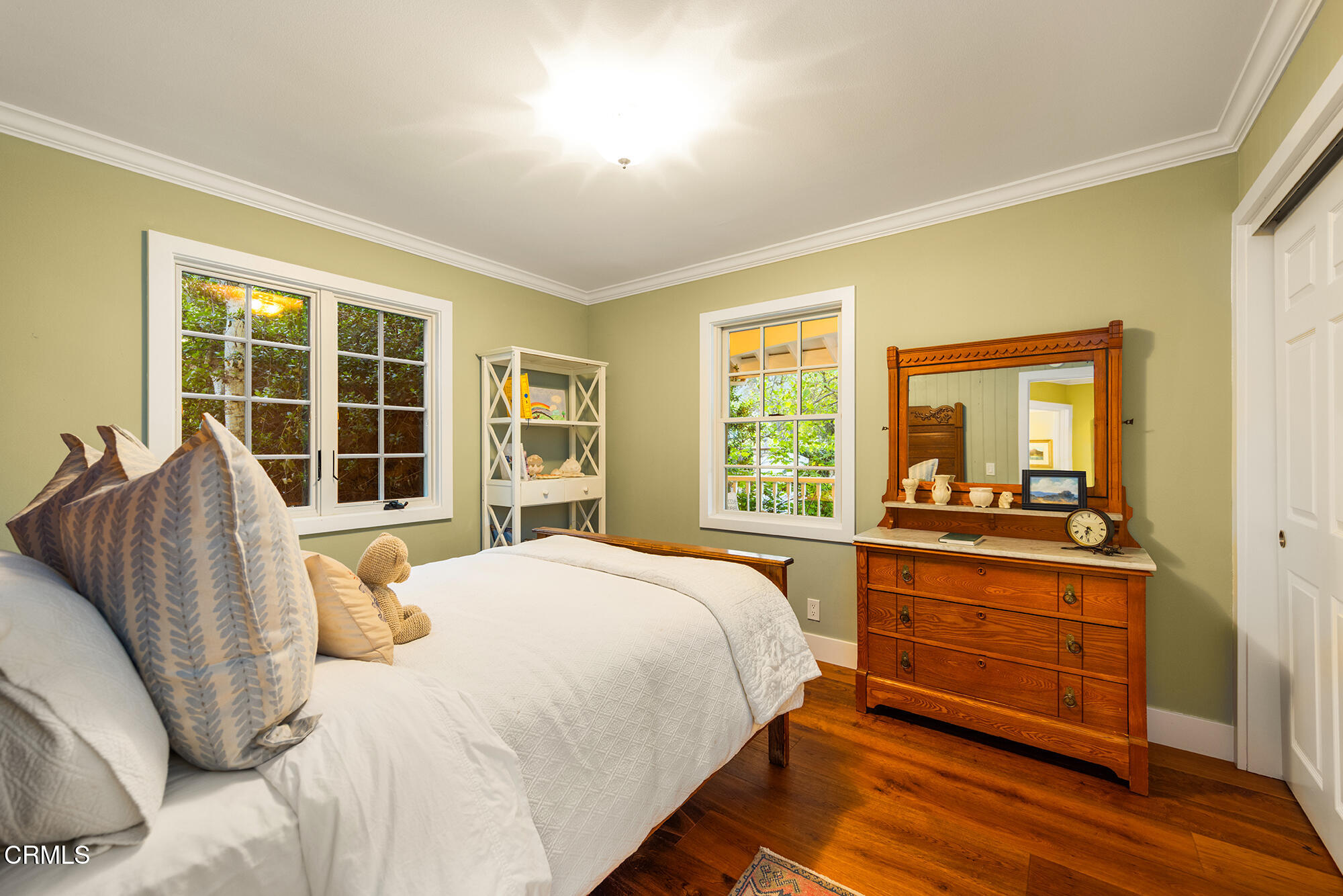 924 Fairview Road Ojai, CA 93023 - Photo 14 of 22 a bedroom with a bed and a large window with wooden floor