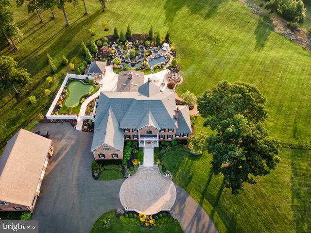 an aerial view of a house with a garden and swimming pool