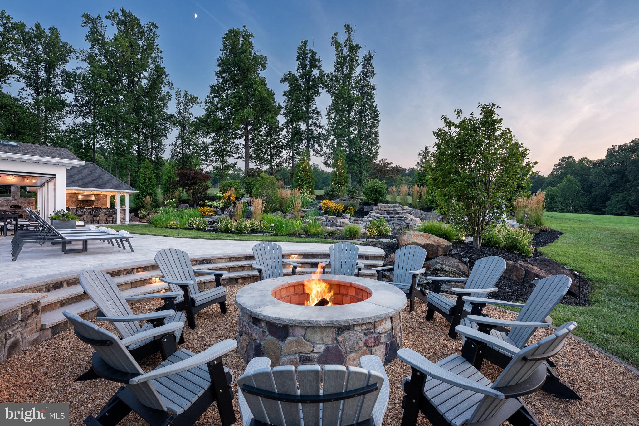 7484 Wilson Road Warrenton, VA 20186 - Photo 19 of 81 a backyard of a house with fire pit and outdoor seating