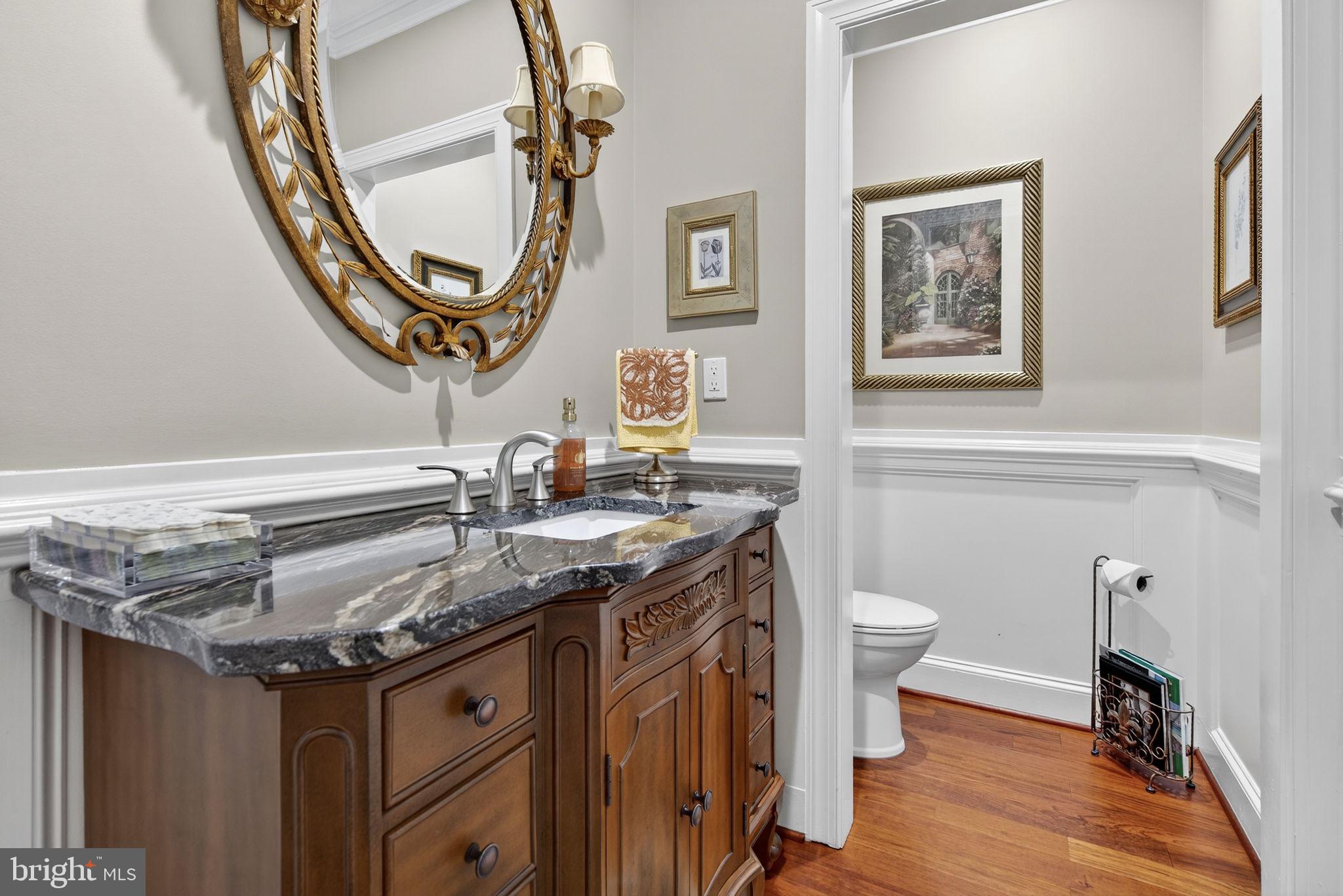 7484 Wilson Road Warrenton, VA 20186 - Photo 39 of 81 a bathroom with a granite countertop toilet sink and mirror