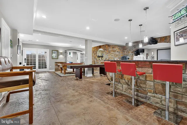 a kitchen with stainless steel appliances granite countertop a sink a stove and a wooden floor