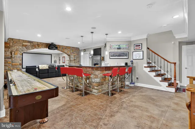 a dining table with chairs and kitchen view