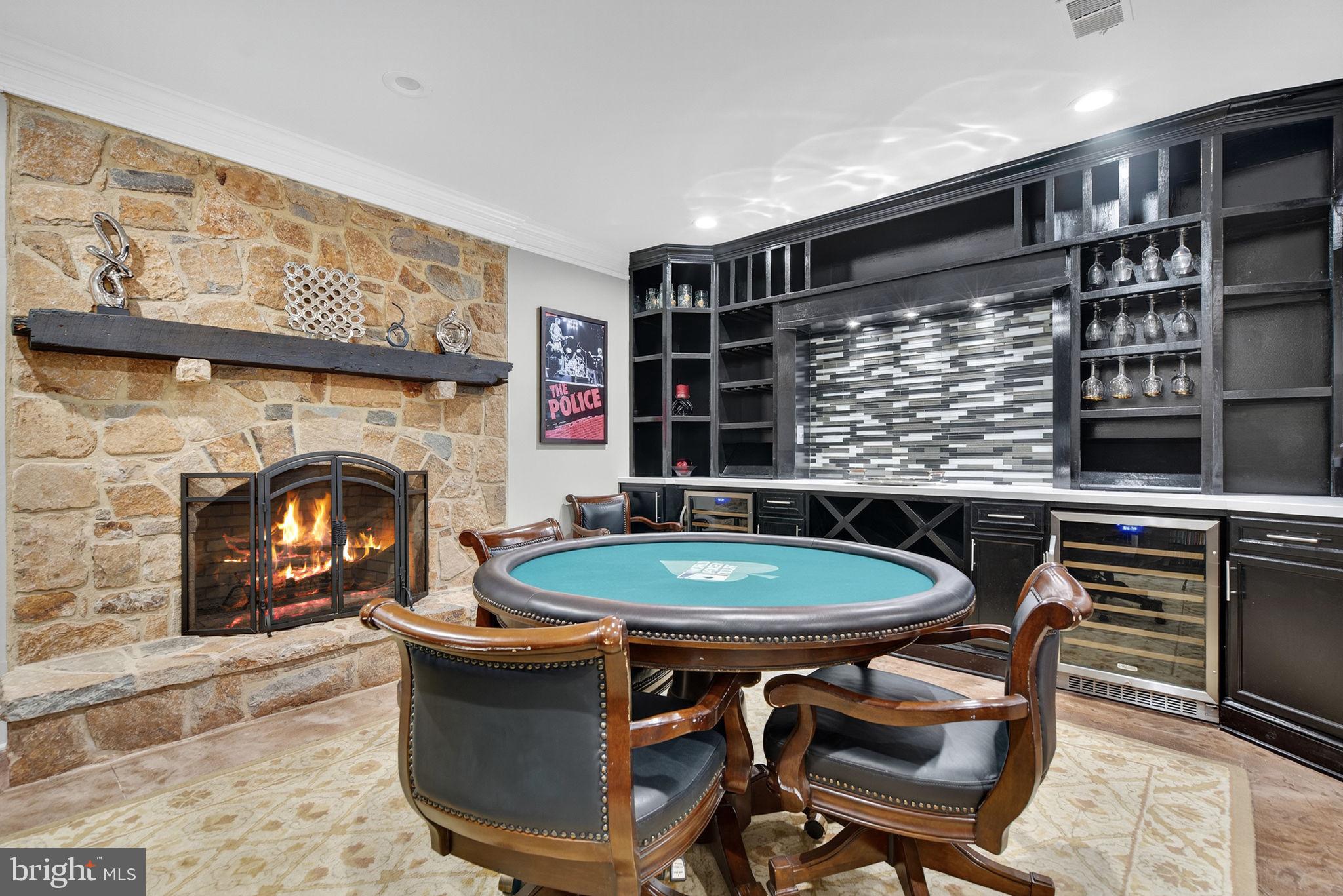 7484 Wilson Road Warrenton, VA 20186 - Photo 46 of 81 a living room with a table chairs and a fireplace