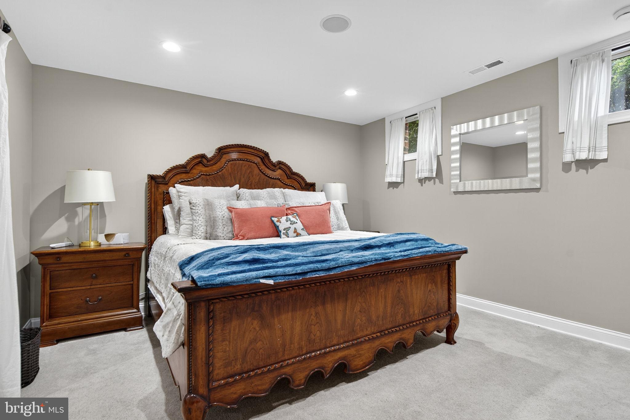 7484 Wilson Road Warrenton, VA 20186 - Photo 49 of 81 a bedroom with a bed and a lamp on dresser