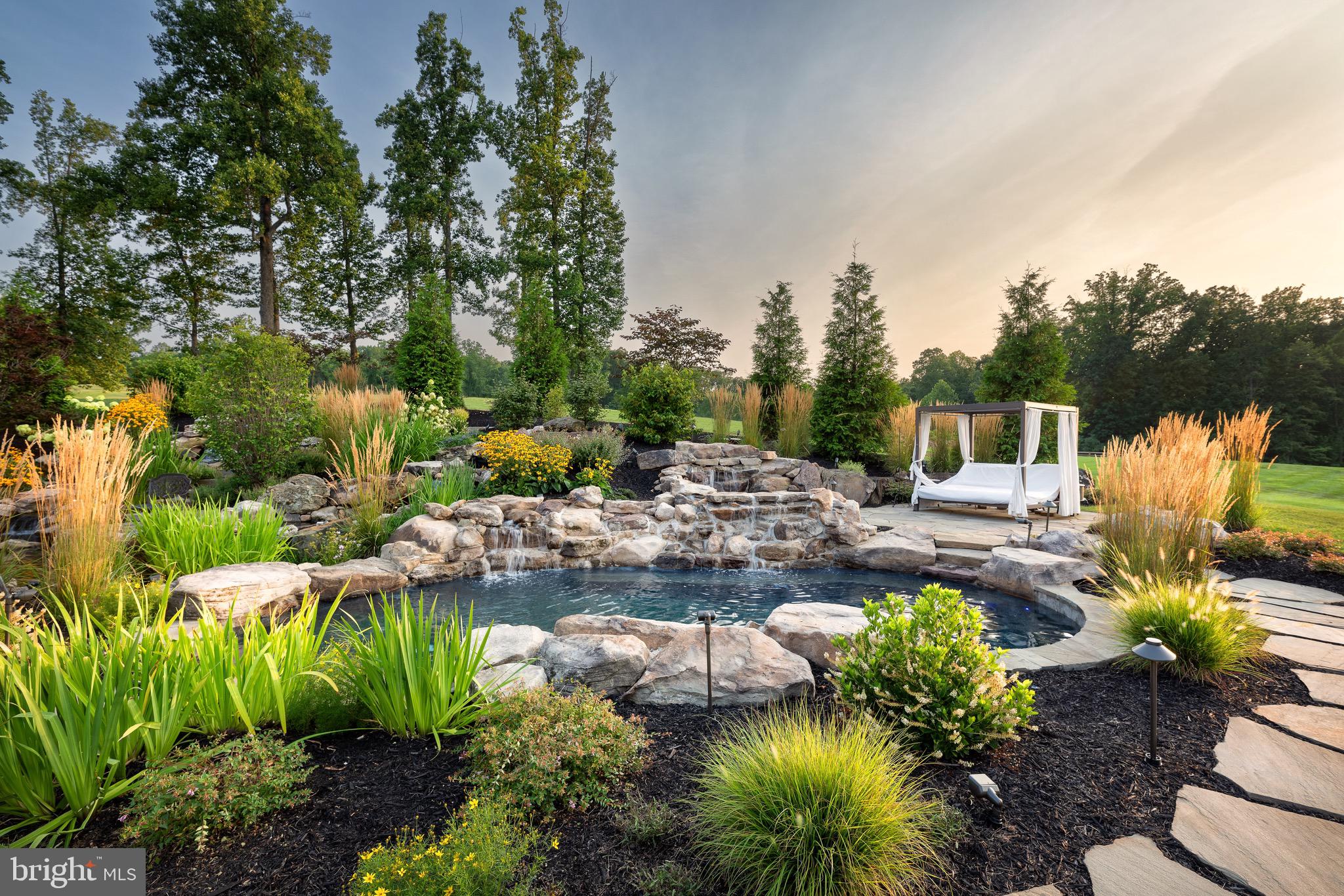 7484 Wilson Road Warrenton, VA 20186 - Photo 6 of 81 a view of a garden with lawn chairs