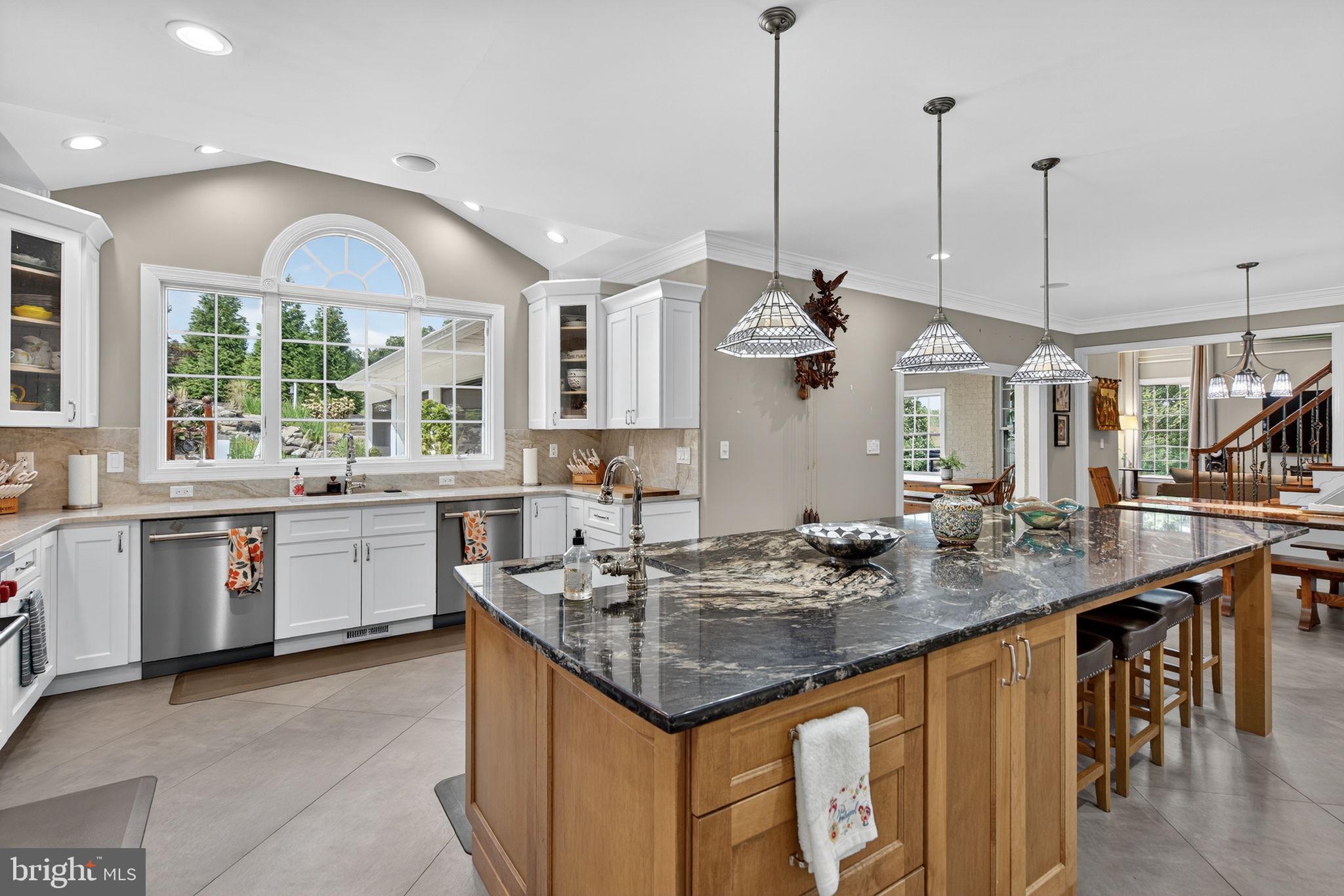 7484 Wilson Road Warrenton, VA 20186 - Photo 64 of 81 a kitchen with stainless steel appliances granite countertop a sink a stove and a wooden floor