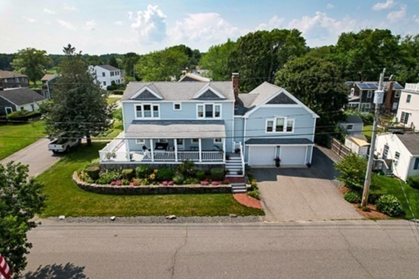 a aerial view of a house next to a yard