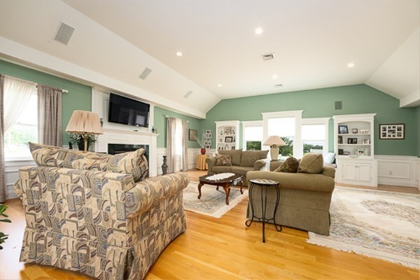 32 Columbus Road Marshfield, MA 02050 - Photo 20 of 37 a living room with fireplace furniture and a flat screen tv