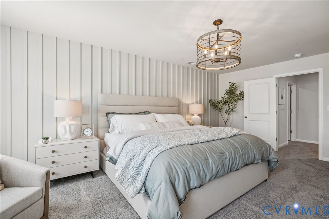 155 Liberty Lane Keswick, VA 22947 - Photo 17 of 32 a bedroom with a bed and a chandelier