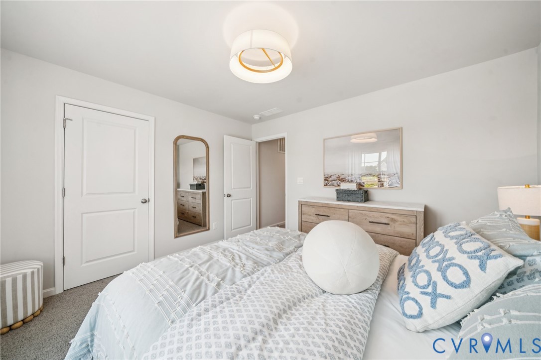155 Liberty Lane Keswick, VA 22947 - Photo 31 of 32 a spacious bedroom with a bed and window