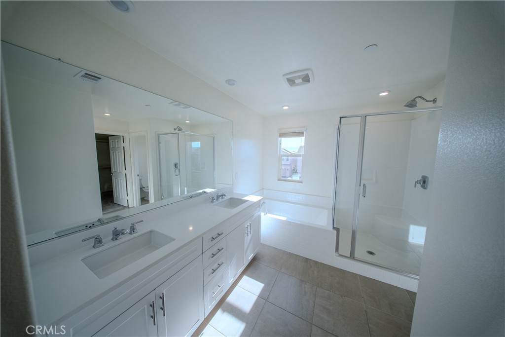 558 Pablo Road Lake Elsinore, CA 92530 - Photo 17 of 20 a bathroom with a double vanity sink mirror and shower