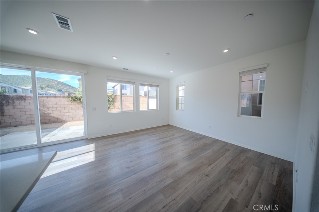 558 Pablo Road Lake Elsinore, CA 92530 - Photo 6 of 20 a view of an empty room with wooden floor and a window