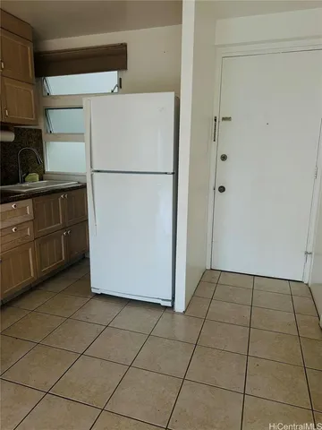 a white refrigerator freezer sitting in a kitchen
