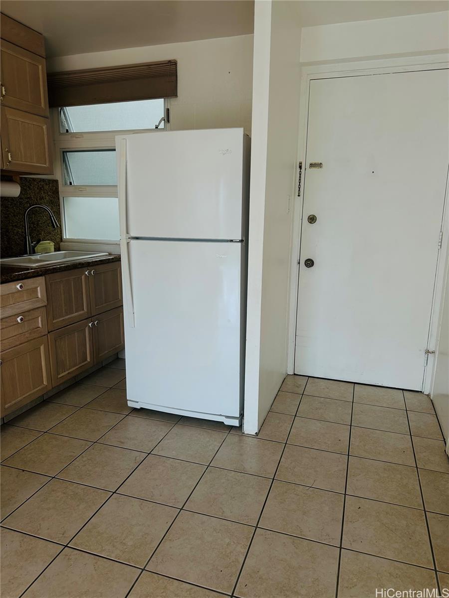 1019 Maunaihi Place, Unit 203 Honolulu, HI 96822 - Photo 12 of 19 a white refrigerator freezer sitting in a kitchen