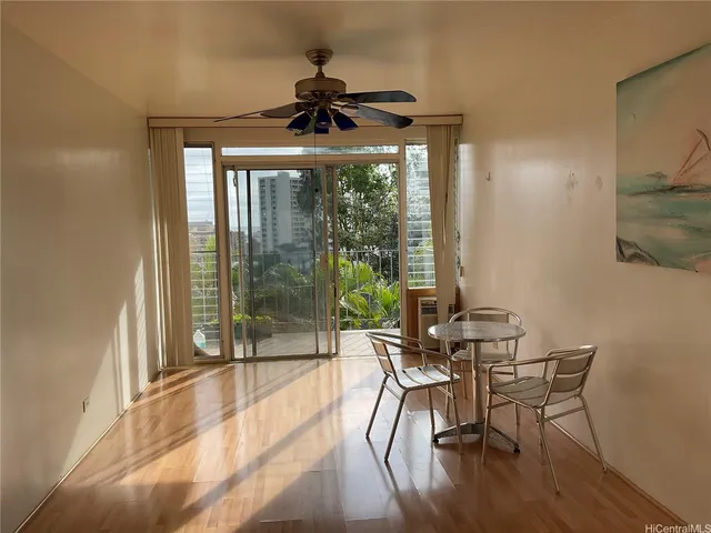 a dining room with furniture wooden floor and a chandelier