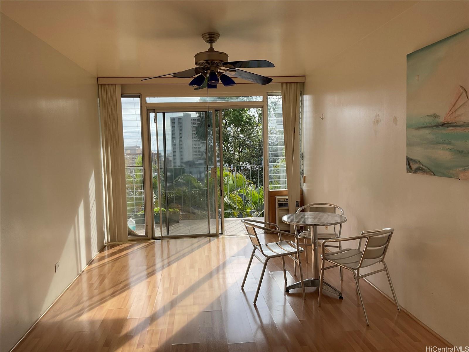 1019 Maunaihi Place, Unit 203 Honolulu, HI 96822 - Photo 13 of 19 a dining room with furniture wooden floor and a chandelier